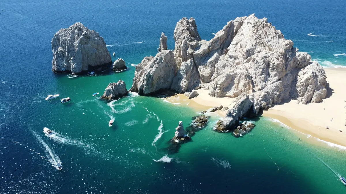 Boats near the arch and its beach seen from the air