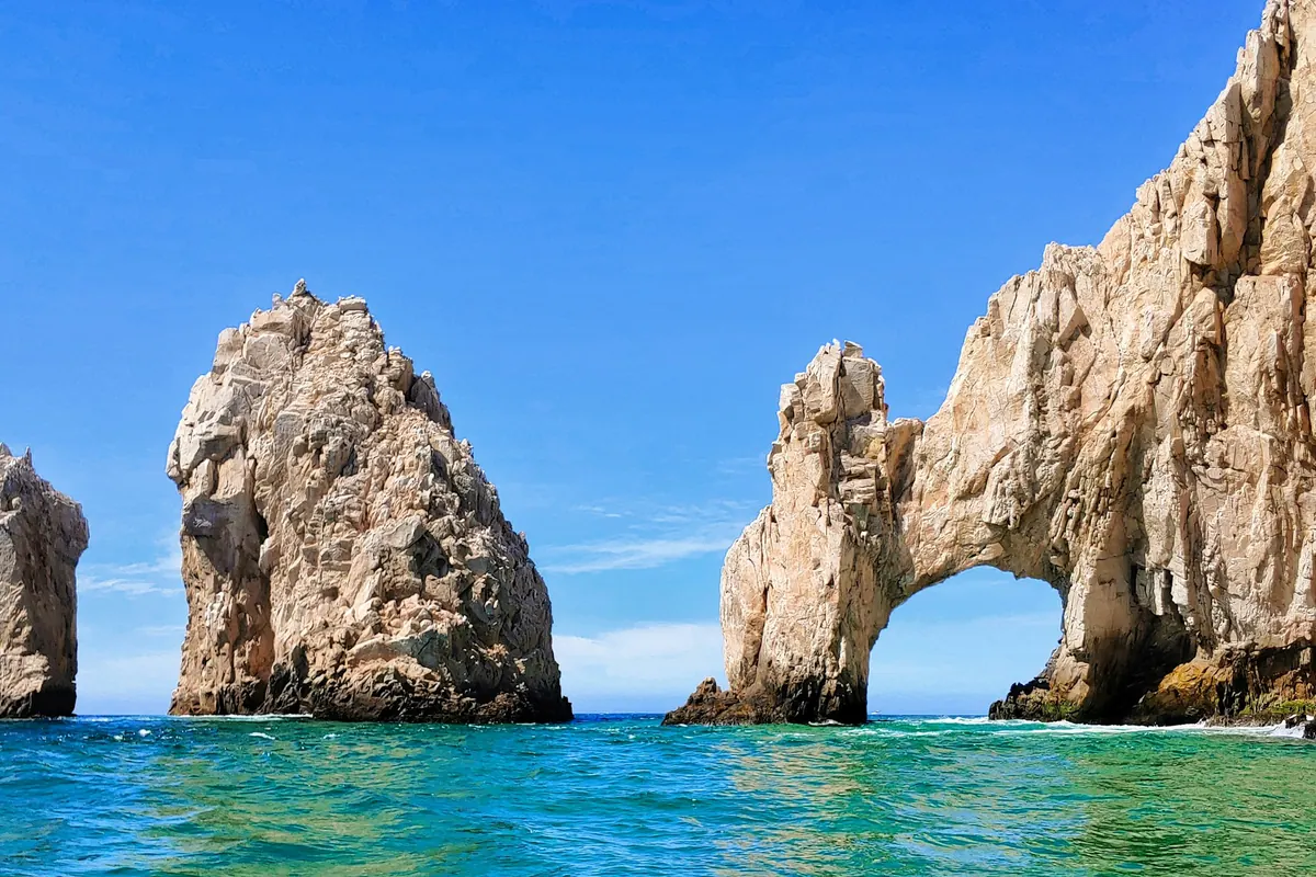 The arch at Land's End under a bright blue sky
